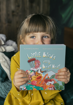 Young girl holding a book.